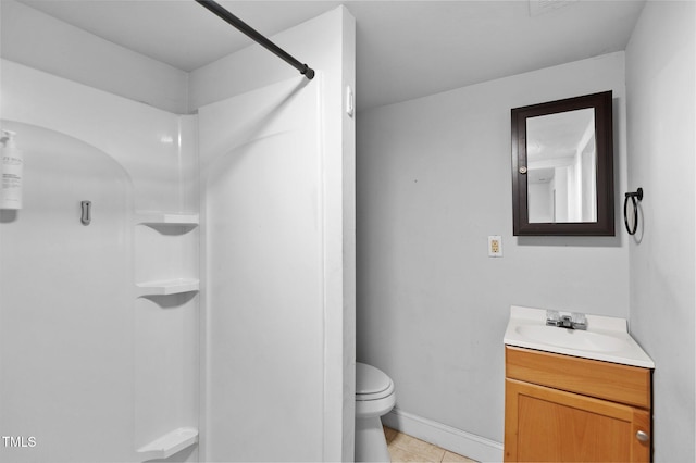 full bath with vanity, baseboards, tile patterned flooring, walk in shower, and toilet