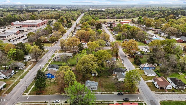 birds eye view of property with a wooded view and a residential view