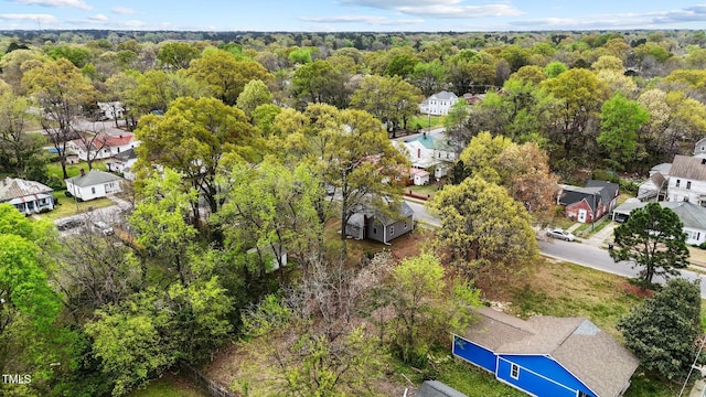 birds eye view of property with a view of trees and a residential view