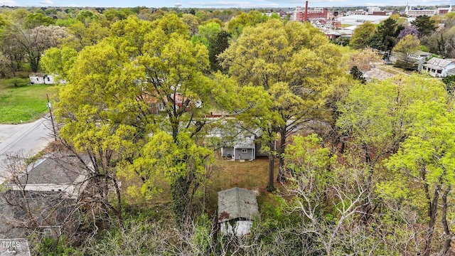 drone / aerial view featuring a wooded view