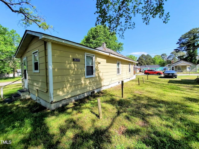 view of home's exterior featuring a yard