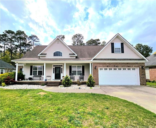 921 Satinwood Ct, Fayetteville, NC 28312 - view of front facade with concrete driveway, brick siding, a garage, a front lawn, and covered porch