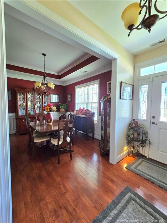 921 Satinwood Ct, Fayetteville, NC 28312 - dining area featuring a chandelier, wood-type flooring, ornamental molding, and a raised ceiling