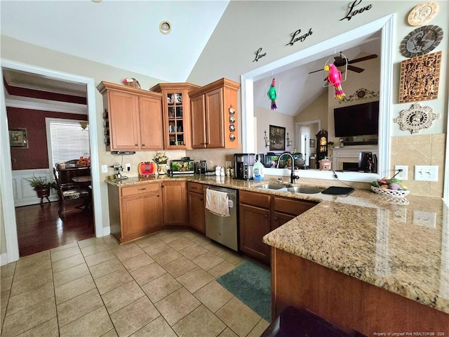 921 Satinwood Ct, Fayetteville, NC 28312 - kitchen featuring dishwasher, a sink, lofted ceiling, light stone counters, and brown cabinets