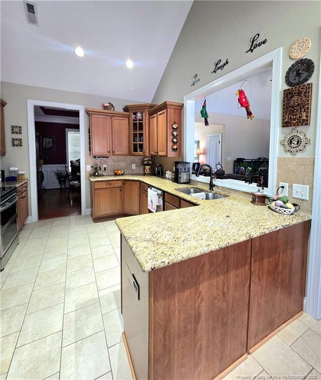 921 Satinwood Ct, Fayetteville, NC 28312 - kitchen with a sink, a peninsula, appliances with stainless steel finishes, glass insert cabinets, and light stone counters