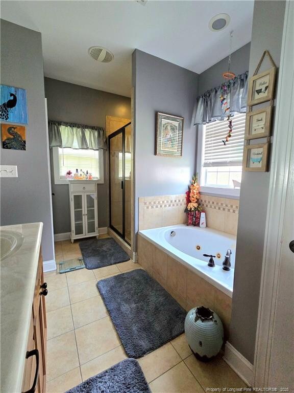 921 Satinwood Ct, Fayetteville, NC 28312 - full bath featuring a whirlpool tub, a stall shower, vanity, and tile patterned floors