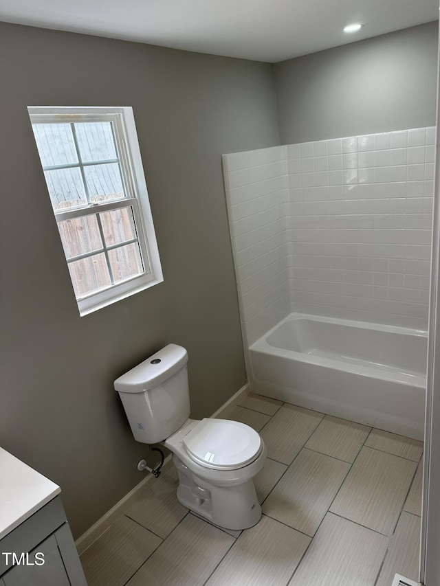 full bath with vanity, tile patterned flooring, toilet, baseboards, and a bathing tub
