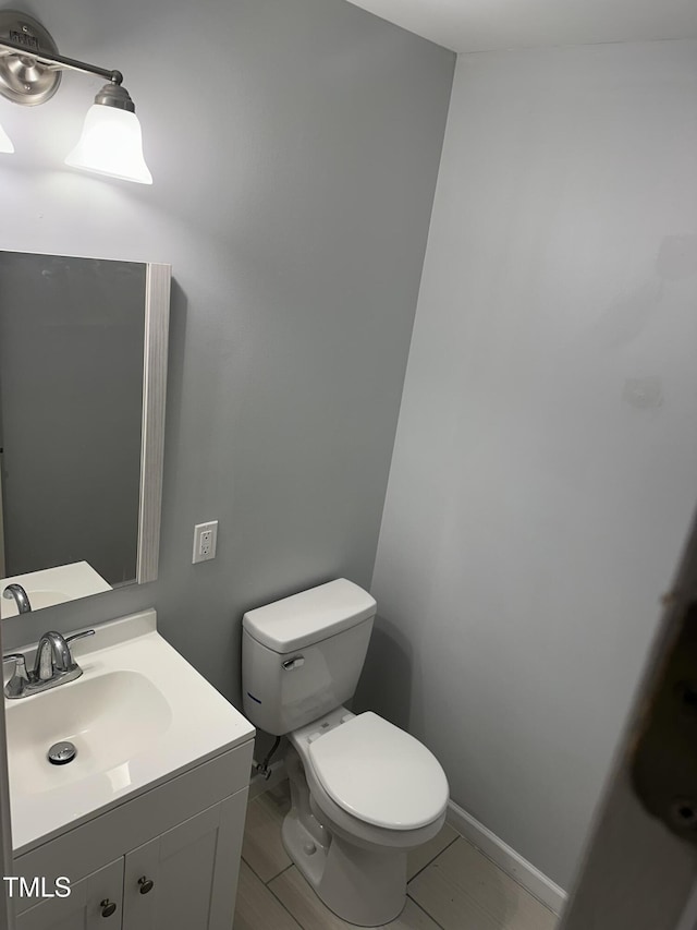 half bath with vanity and toilet