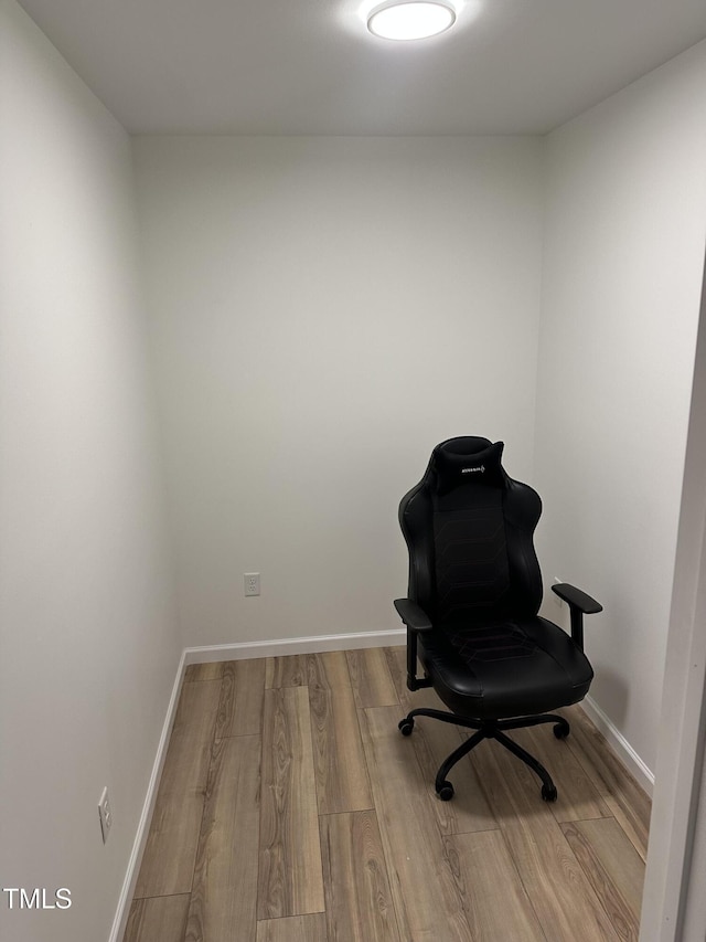 sitting room featuring baseboards and wood finished floors