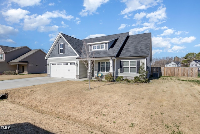 view of front of home with roof with shingles, driveway, cooling unit, an attached garage, and fence