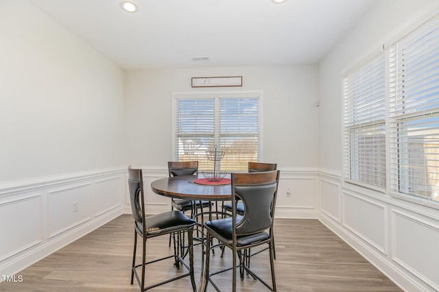 dining space featuring a healthy amount of sunlight, light wood finished floors, visible vents, and recessed lighting