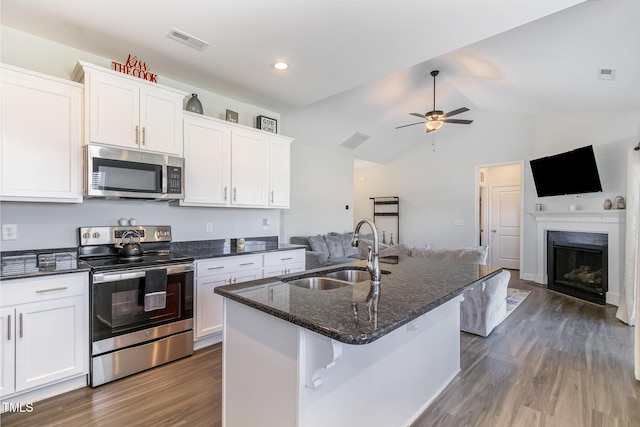 kitchen with a sink, open floor plan, visible vents, and stainless steel appliances