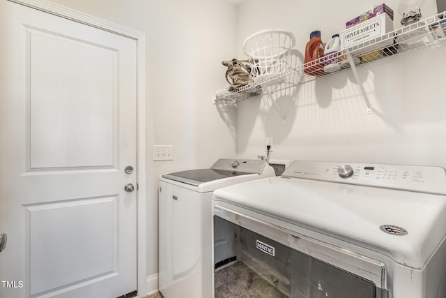 laundry room featuring washer and clothes dryer, tile patterned flooring, and laundry area