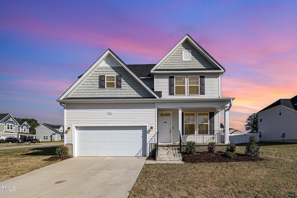 15 Woodworkers Way, Clayton, NC 27520 - view of front of property with a garage, a yard, a porch, and driveway