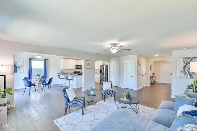 2065 Alderman Way, Creedmoor, NC 27522 - living room featuring baseboards, a ceiling fan, arched walkways, and wood finished floors