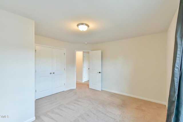 2065 Alderman Way, Creedmoor, NC 27522 - unfurnished bedroom with a closet, baseboards, and light carpet