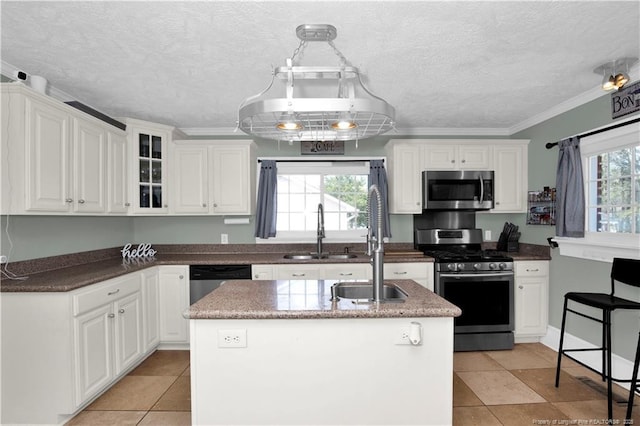 416 N Main St, Raeford, NC 28376 - kitchen with white cabinets, a textured ceiling, a sink, and appliances with stainless steel finishes