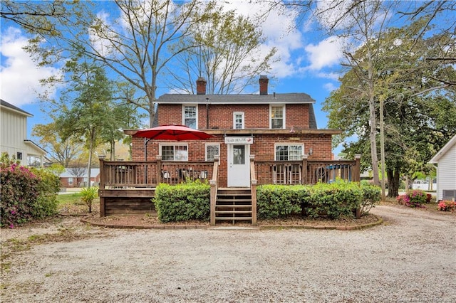 416 N Main St, Raeford, NC 28376 - rear view of property with brick siding, a wooden deck, and a chimney