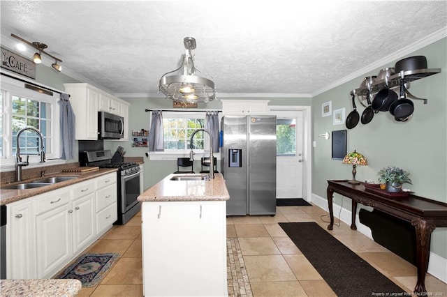 416 N Main St, Raeford, NC 28376 - kitchen with a kitchen island with sink, a sink, ornamental molding, and appliances with stainless steel finishes