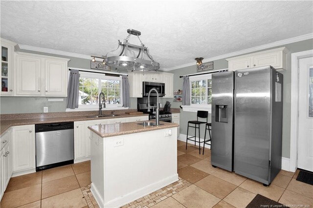 416 N Main St, Raeford, NC 28376 - kitchen featuring a sink, ornamental molding, white cabinets, and stainless steel appliances