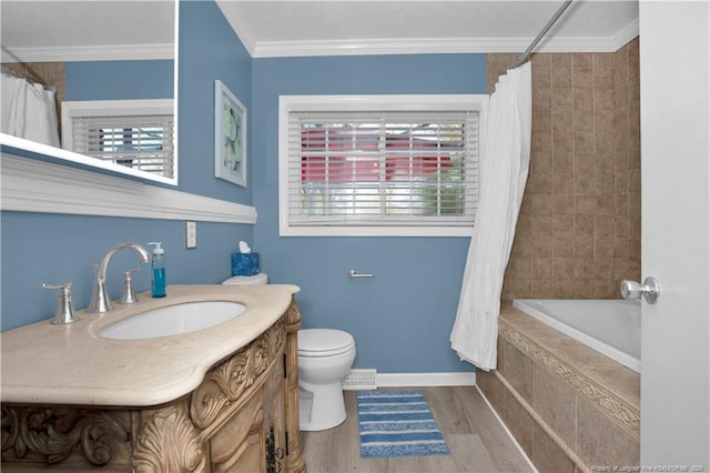 416 N Main St, Raeford, NC 28376 - bathroom with wood finished floors, vanity, ornamental molding, and a wealth of natural light