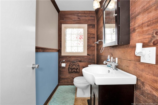 416 N Main St, Raeford, NC 28376 - bathroom featuring wood walls, vanity, ornamental molding, and toilet