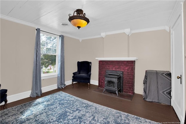 416 N Main St, Raeford, NC 28376 - sitting room featuring a wood stove, baseboards, ornamental molding, and wood finished floors