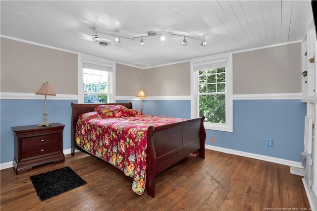 416 N Main St, Raeford, NC 28376 - bedroom featuring baseboards, track lighting, crown molding, visible vents, and hardwood / wood-style flooring