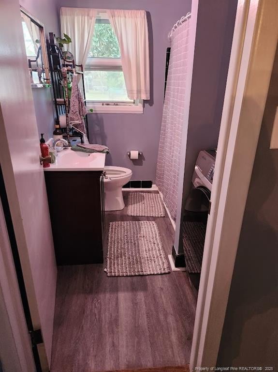4017 Glenridge Rd, Fayetteville, NC 28304 - bathroom with wood finished floors, toilet, vanity, and a shower with shower curtain