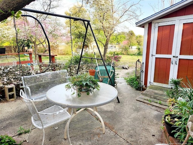 4017 Glenridge Rd, Fayetteville, NC 28304 - view of patio featuring a storage unit, an outdoor structure, and outdoor dining space