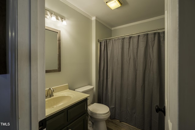 bathroom with wood finished floors, toilet, vanity, a shower with curtain, and crown molding