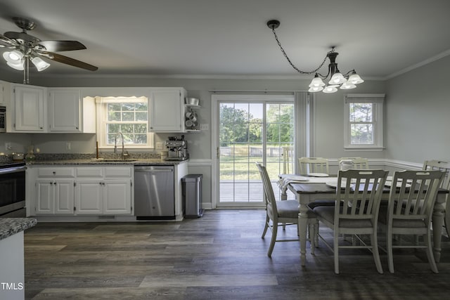 dining area with dark wood-style flooring, a healthy amount of sunlight, ornamental molding, and ceiling fan with notable chandelier
