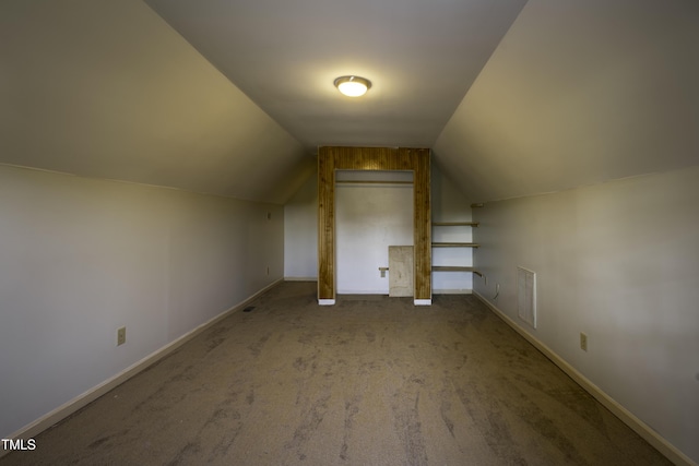 additional living space featuring lofted ceiling, baseboards, visible vents, and carpet
