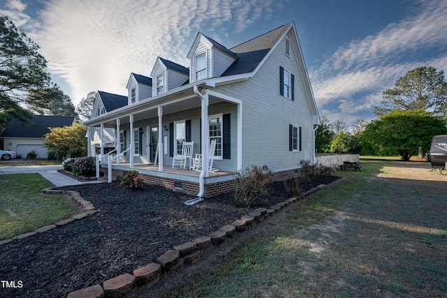 view of side of home featuring a lawn and a porch