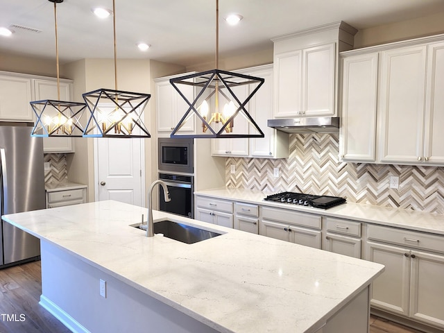 413 Diversity Way, Raleigh, NC 27610 - kitchen featuring stainless steel appliances, a sink, a kitchen island with sink, decorative backsplash, and light stone counters