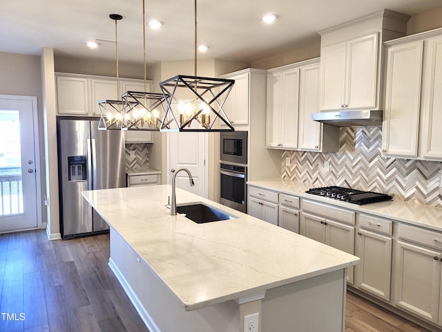 413 Diversity Way, Raleigh, NC 27610 - kitchen with stainless steel appliances, a sink, a center island with sink, under cabinet range hood, and tasteful backsplash