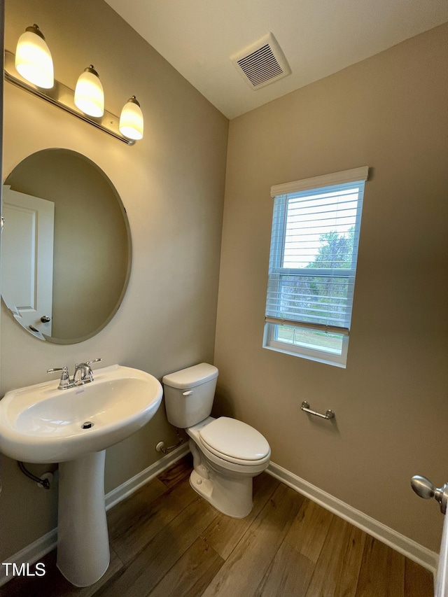 413 Diversity Way, Raleigh, NC 27610 - bathroom featuring toilet, wood finished floors, baseboards, and a sink