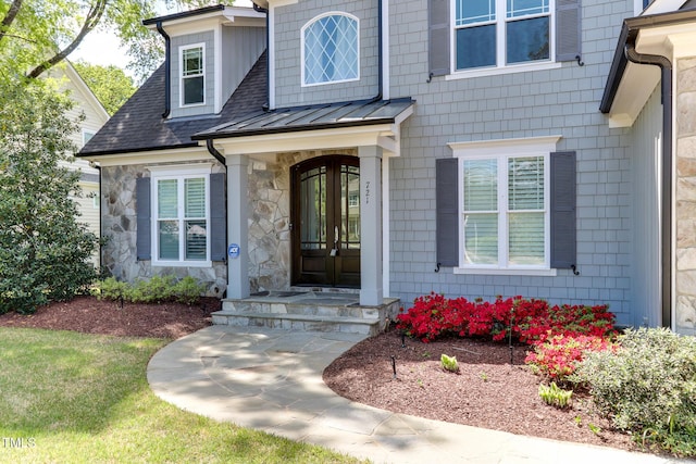 721 Shelley Rd, Raleigh, NC 27609 - view of exterior entry featuring roof with shingles and stone siding