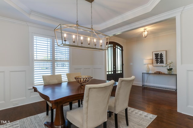 721 Shelley Rd, Raleigh, NC 27609 - dining area featuring a wainscoted wall, wood finished floors, a chandelier, and a decorative wall