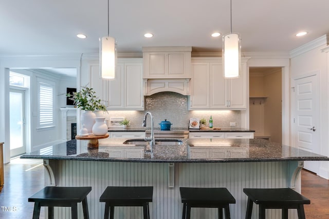 721 Shelley Rd, Raleigh, NC 27609 - kitchen featuring backsplash, crown molding, dark wood-style flooring, and a sink