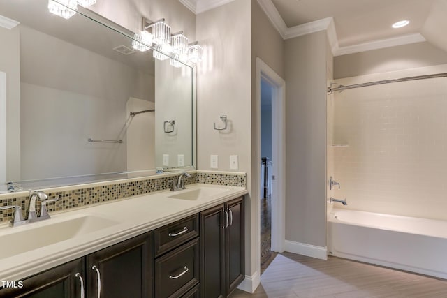 721 Shelley Rd, Raleigh, NC 27609 - full bathroom featuring decorative backsplash, wood finished floors, a sink, and crown molding