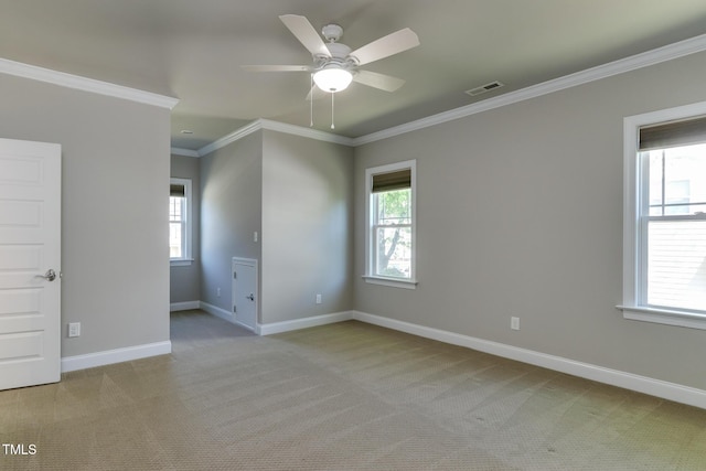 721 Shelley Rd, Raleigh, NC 27609 - unfurnished room featuring crown molding, ceiling fan, light colored carpet, baseboards, and visible vents