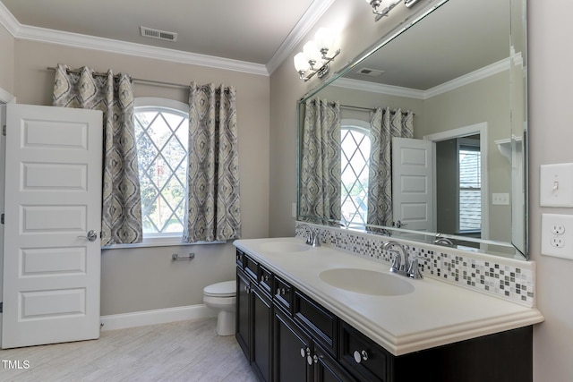 721 Shelley Rd, Raleigh, NC 27609 - bathroom with baseboards, ornamental molding, a sink, and visible vents