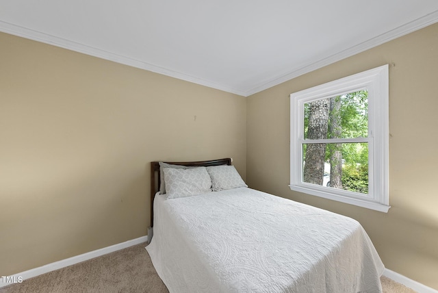 carpeted bedroom with baseboards and ornamental molding