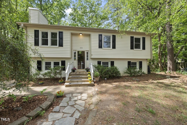 bi-level home featuring a chimney