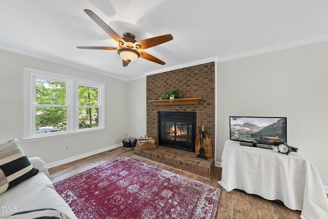 living room with a fireplace, wood finished floors, and ornamental molding