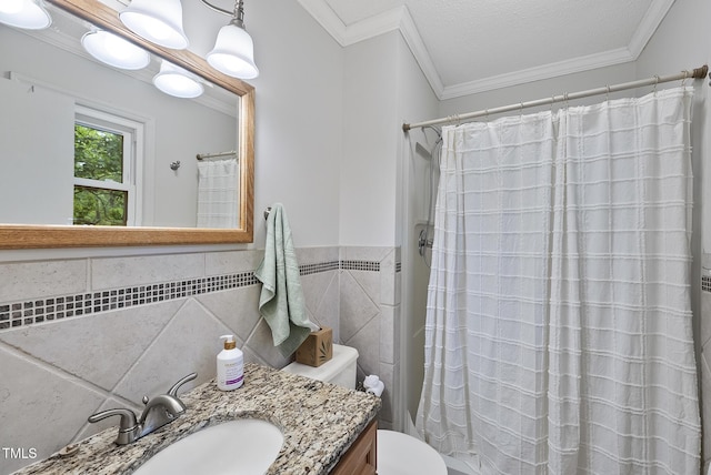 bathroom featuring toilet, vanity, ornamental molding, a shower with curtain, and tile walls