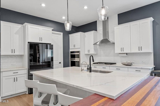 956 The Parks Dr, Pittsboro, NC 27312 - kitchen featuring a kitchen breakfast bar, backsplash, white cabinets, appliances with stainless steel finishes, and a sink