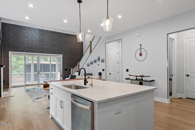 956 The Parks Dr, Pittsboro, NC 27312 - kitchen featuring light stone counters, white cabinetry, light wood-style floors, stainless steel dishwasher, and a sink
