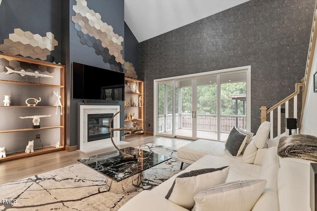 956 The Parks Dr, Pittsboro, NC 27312 - living area featuring high vaulted ceiling, a high end fireplace, and wood finished floors